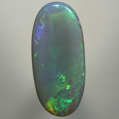 SOLID SEMI BLACK OPAL Green moves over a large opal